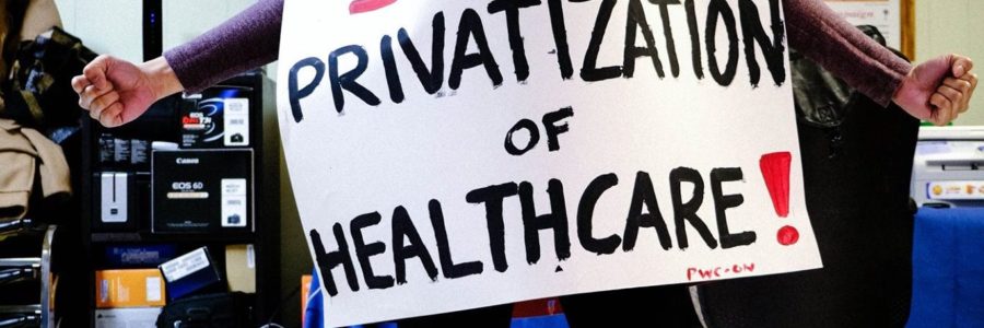 Young woman holding a sign saying "stop privatization of healthcare!"